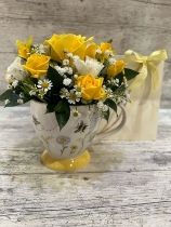 yellow and cream bumblebee cup arrangement in gift bag